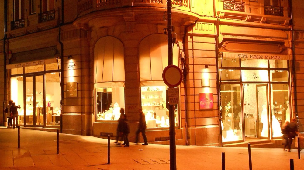 A lit shop window on a Porto corner at night